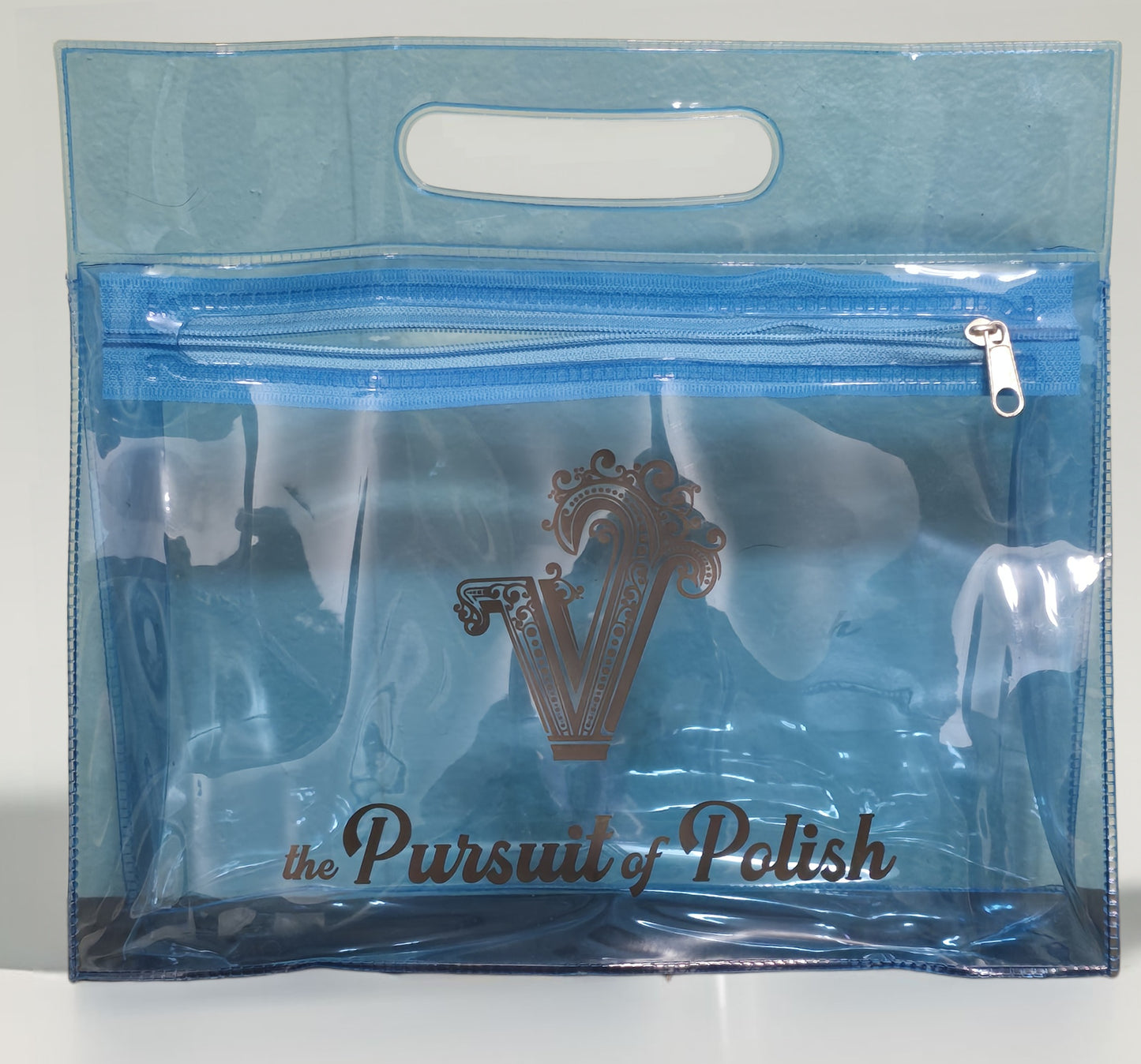 Clear blue pouch with 'the Pursuit of Polish' branding on a white background