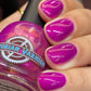 Hand with purple nail polish holding a jar of Victorian Varnish nail polish.