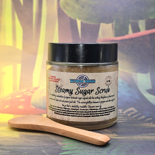 Jar of steamy sugar scrub with a wooden spoon on a colorful background