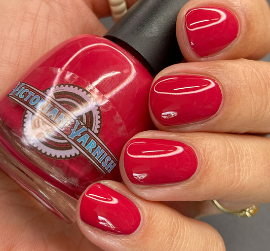 Cherry Red creme with a pinky cool undertone.   Application: Roll bottle between hands or shake to mix any settling of pigments, twist off cap and apply to nail and place magnet over the nail for 10-30 seconds to achieve a magnetic line,  let dry and apply a topcoat and magnetize once more to seal it in.